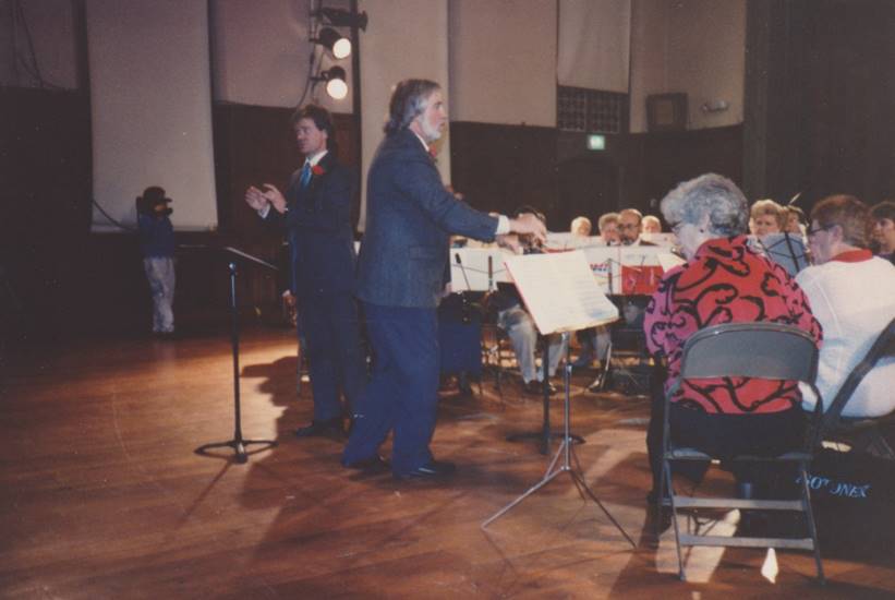 Roy Ernst directing early concert.

Description automatically generated